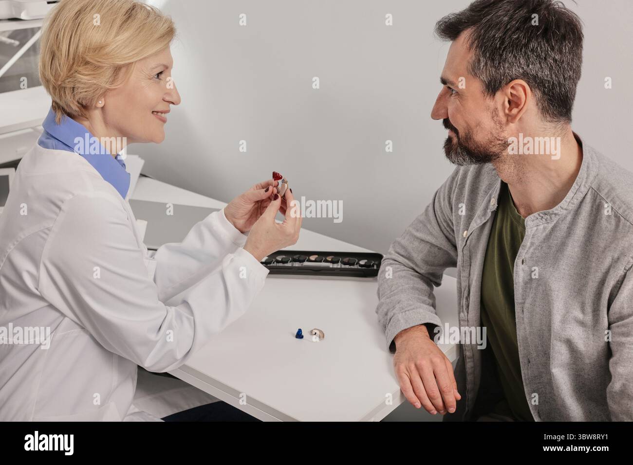 Man inserts hearing aid ear hi-res stock photography and images - Alamy
