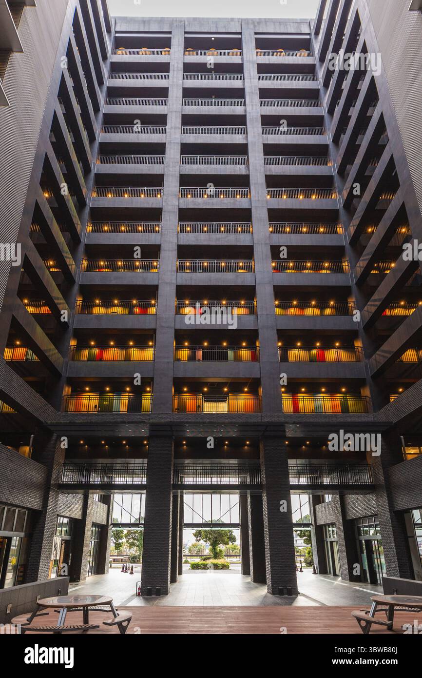 Modern building interior courtyard with multiple floors of balconies ...