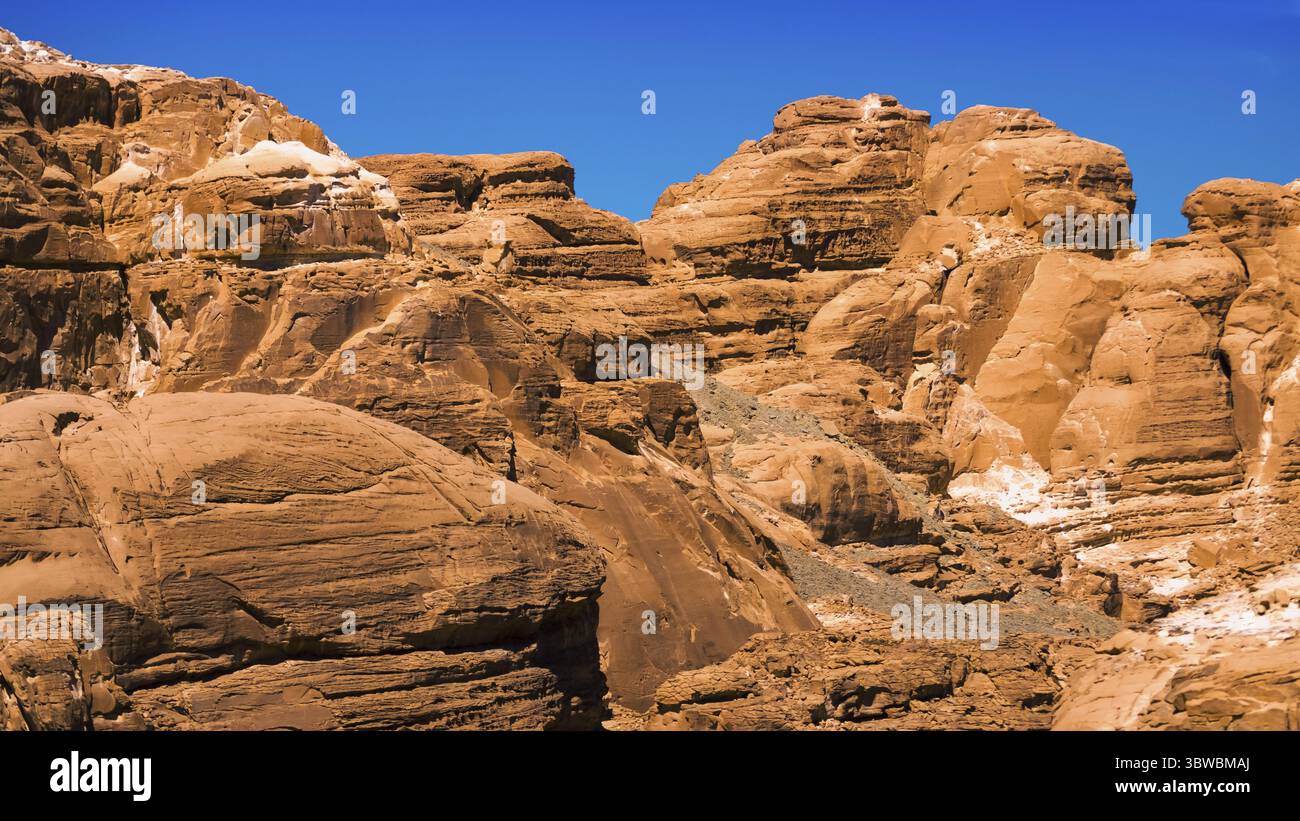 Peaks of high stone rocks against a blue sky in Egypt Dahab South Sinai ...