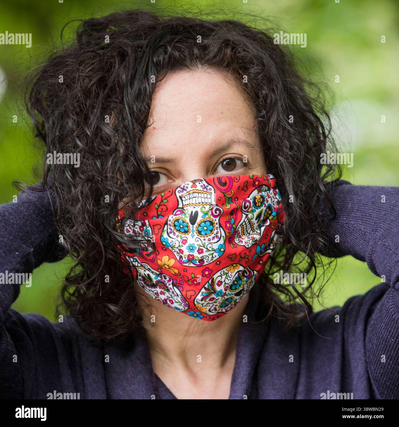 May 22, 2020, Portland, Oregon, USA: DAYNA VELASCO, Energy Healer at Lunasol Polarity Therapy, says,''I chose this sugar skull mask because of my Mexican heritage. In our culture, we choose to step closer to death by celebrating the Day of the Dead. This helps alleviate some of the fears associated with dying. This mask makes me feel more brave about facing the pandemic. Wearing a mask is essential to my work as an energy healer. Now that my practice has opened back up, I am always protecting myself and my clients. This mask was made by my friend Mari in New Mexico, who has made hundreds of ma Stock Photo