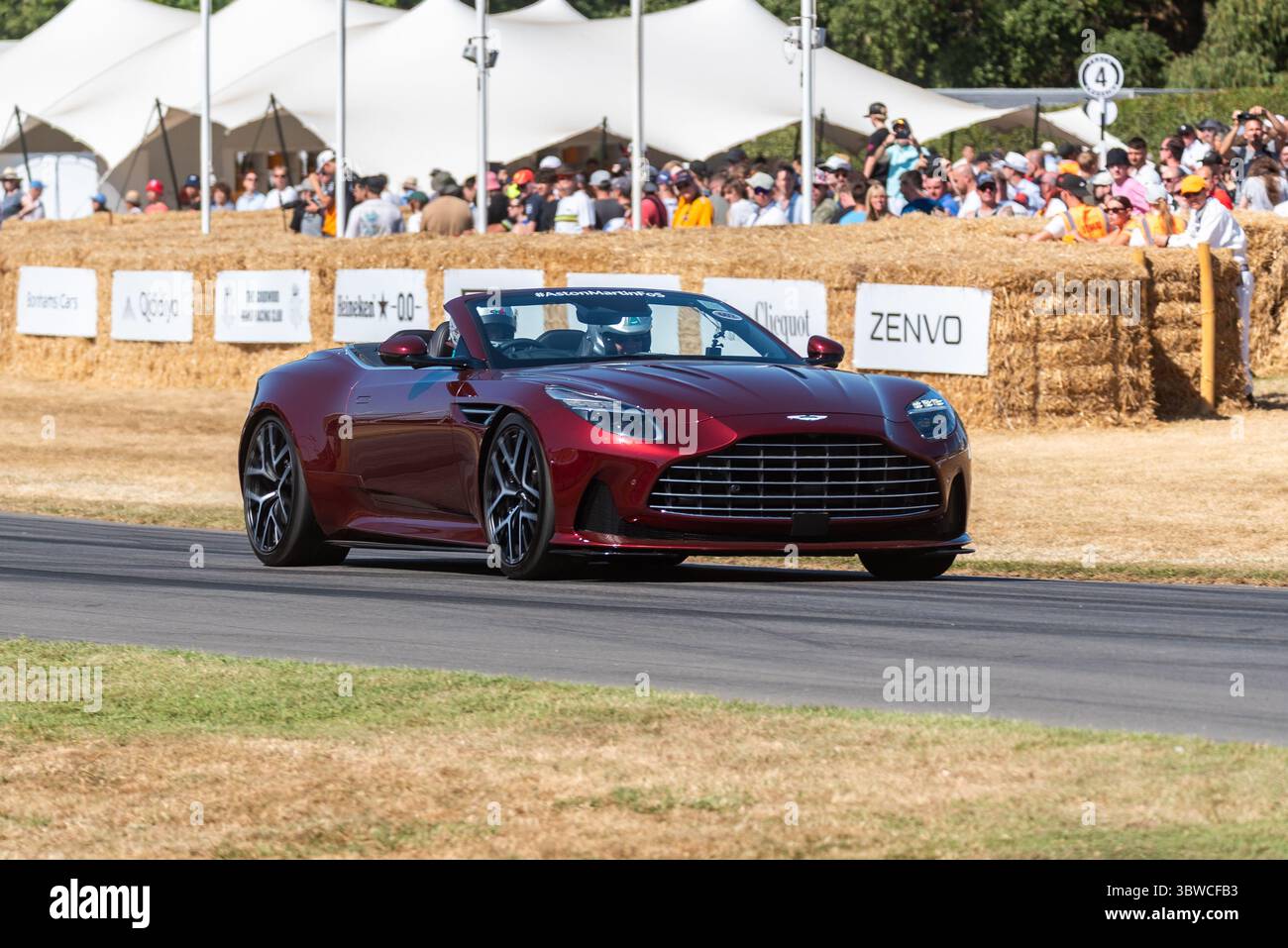 Aston Martin DB12 Volante grand touring car driving up the hillclimb ...