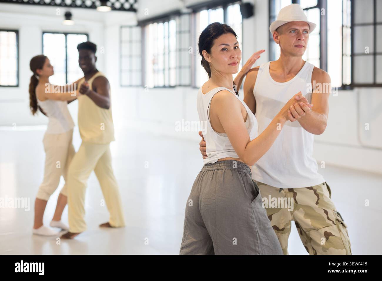 Four dancers exercising bachata movements Stock Photo