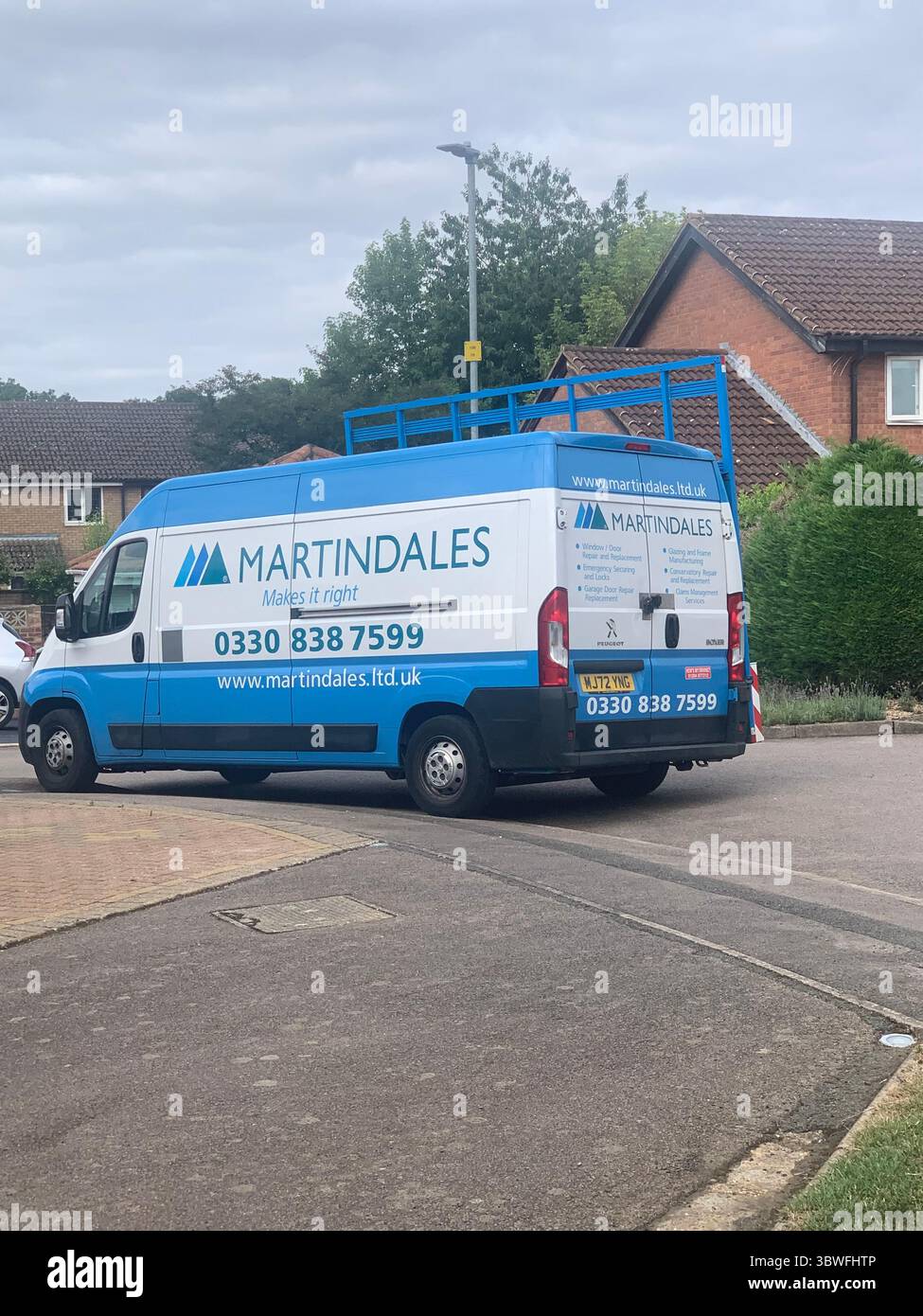 Van large big Martindales window fitters fit fitters outside a house conservatory's conservatory work workmen shop fitters vehicle glass doors - Smartphone Captured Stock Image