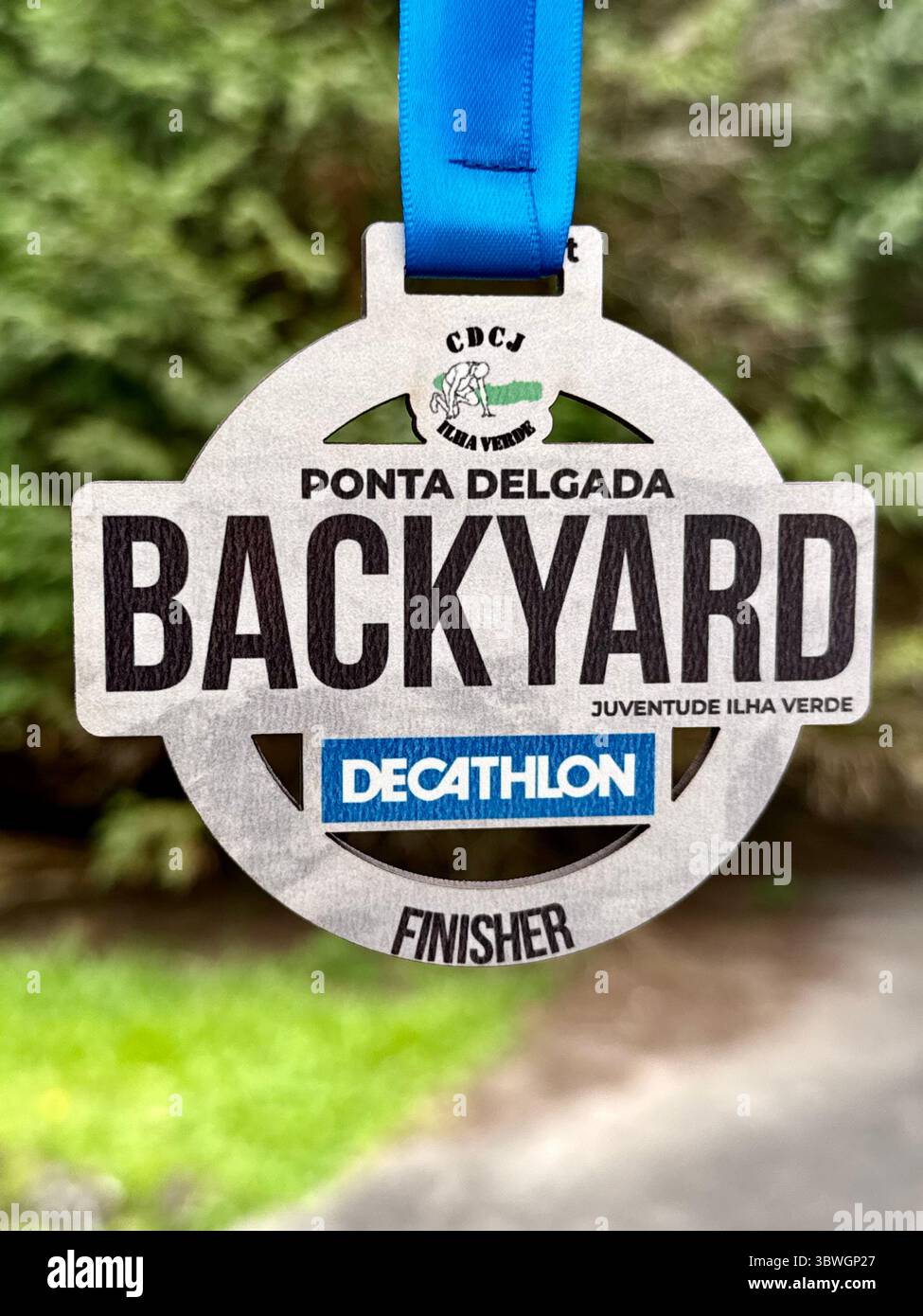 Finisher medal from the Backyard Ultra race in Ponta Delgada, Azores, Portugal - Smartphone Captured Stock Image