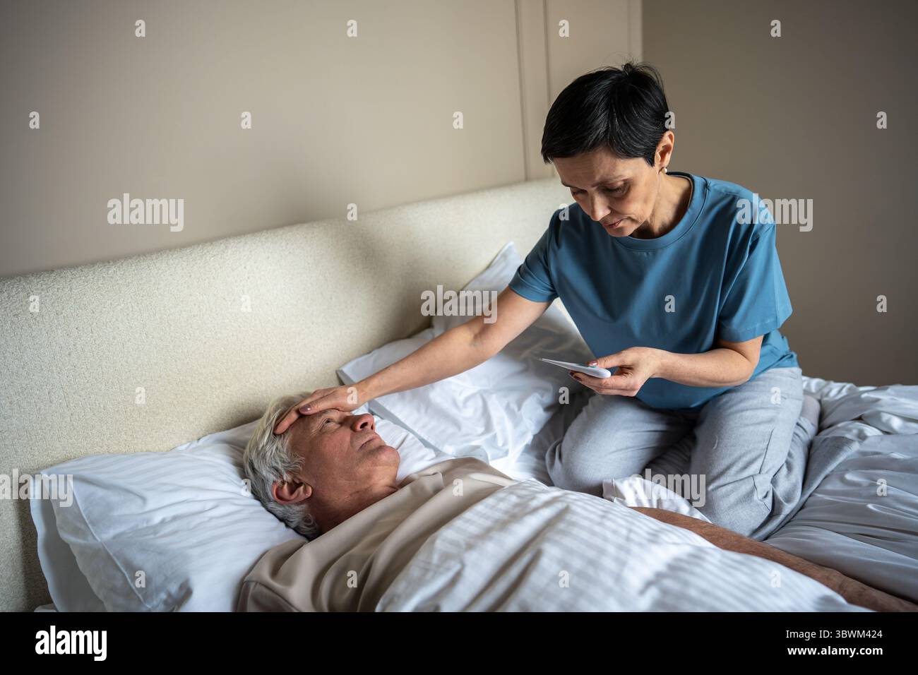 Sick Partner Worried woman check fever of sick partner in bed using thermometer ...