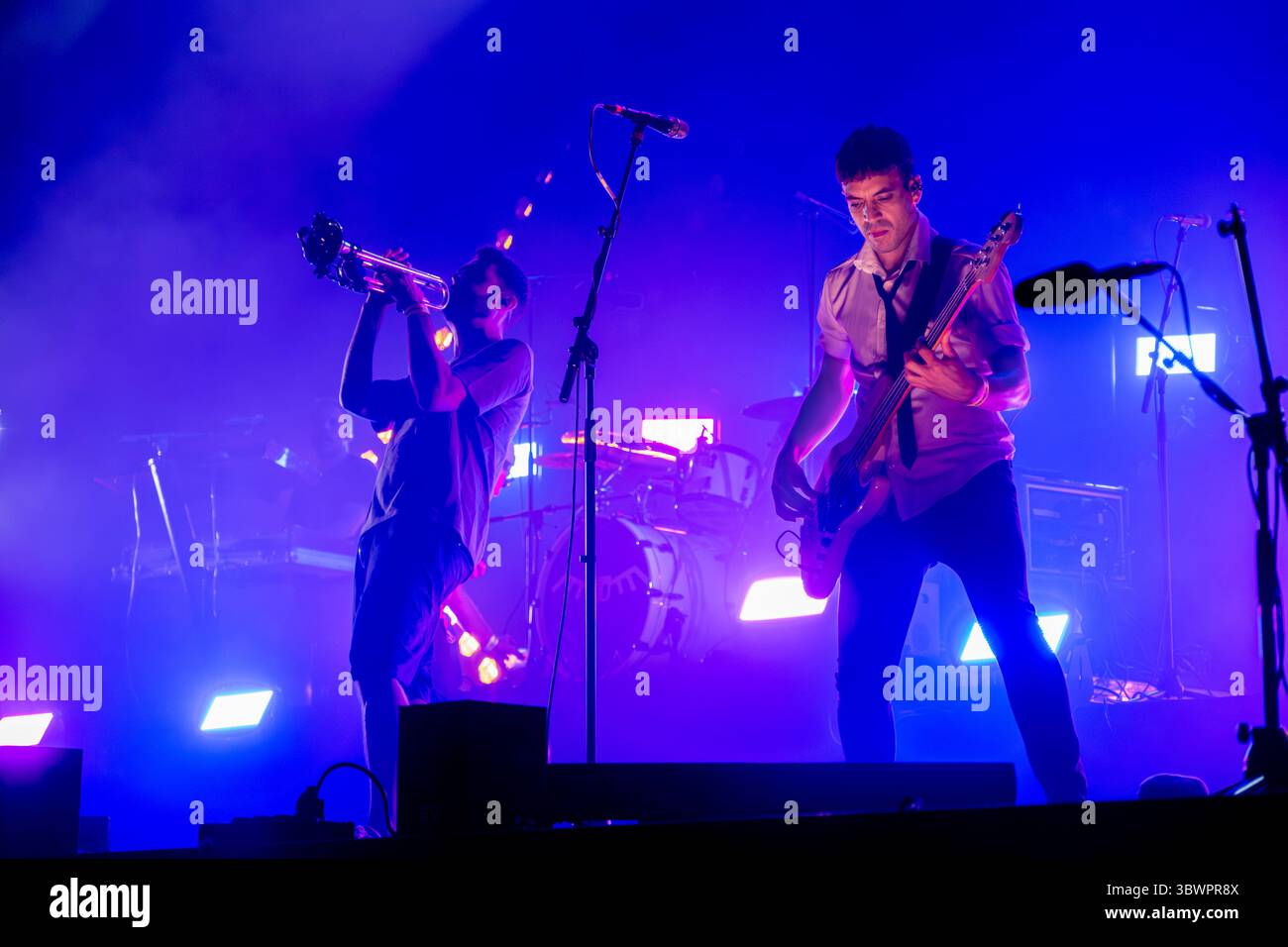 Trumpet Player and Saxophonist of Buhos Band Live Concert at Festival Paupaterres Tarrega with Purple Stage Lighting. Catalan Rock Band Performance, M Stock Photo