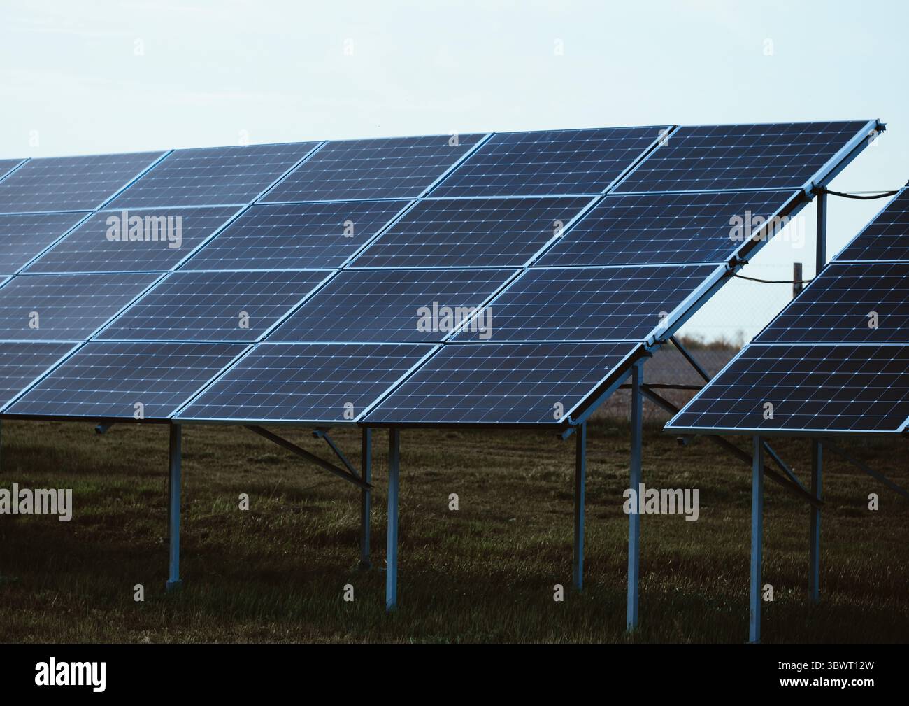 Ground-mounted solar panel array , crystalline silicon panels angled to ...