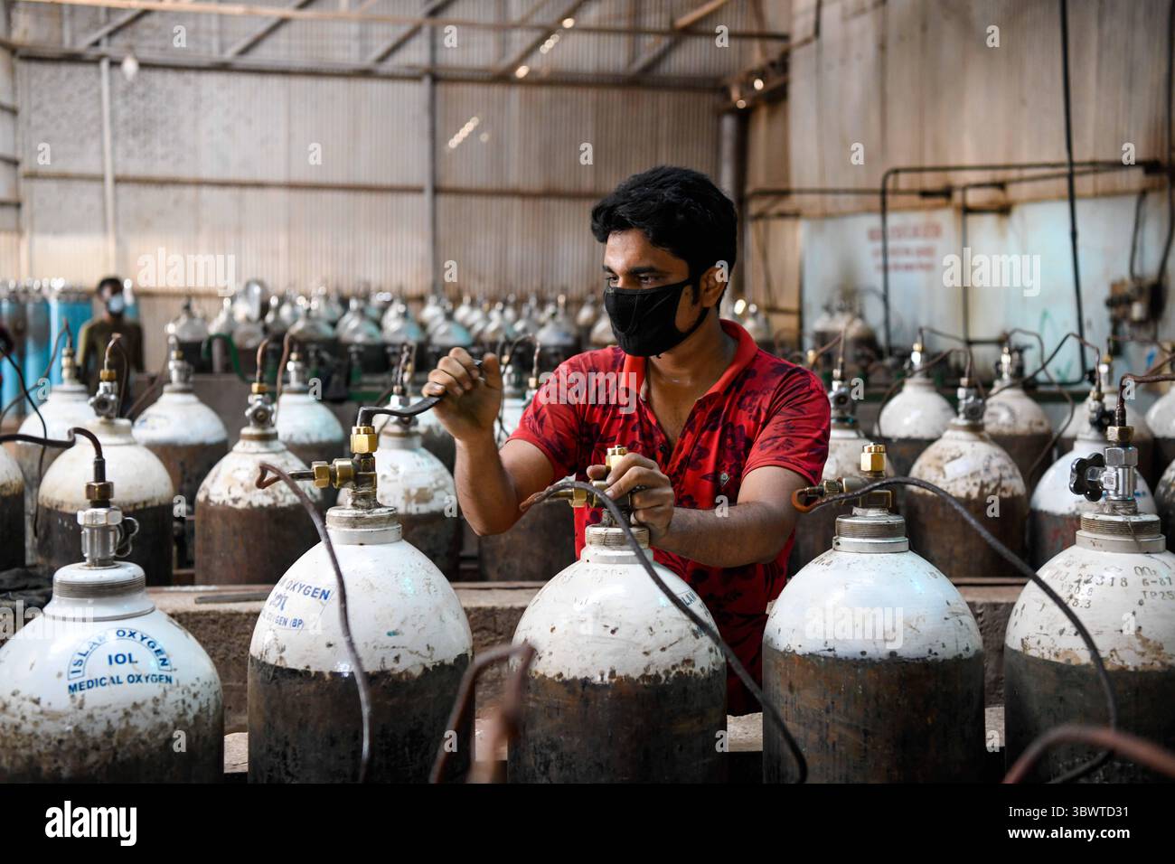 July 8, 2021, Dhaka, Bangladesh: A worker refills oxygen cylinders ...