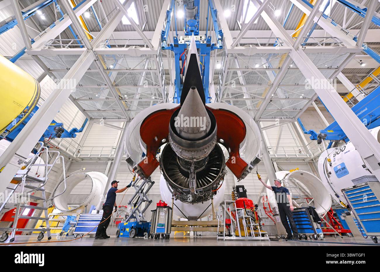 17 July 2025, Thuringia, Arnstadt: Employees work on a Trent XWB engine ...