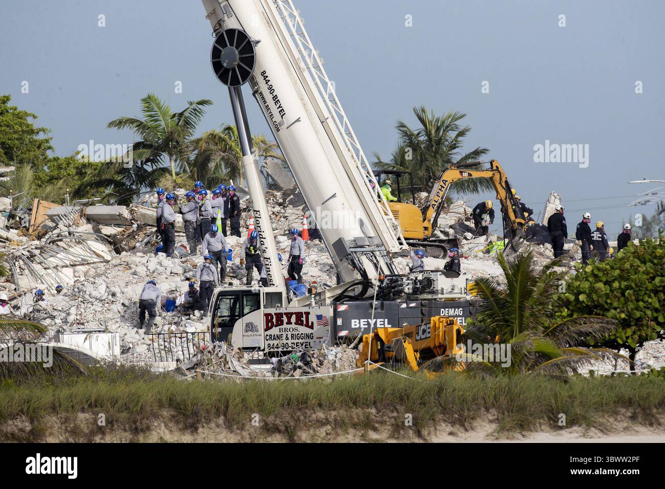 July 8, 2021: Rescue workers search for survivors and remains in the