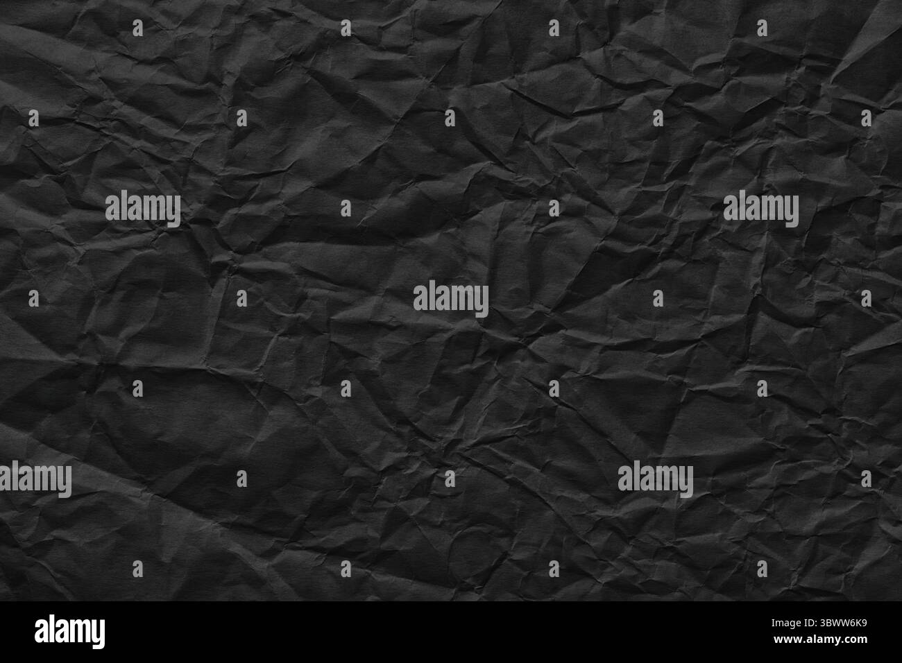 black crumpled paper background, rough page texture Stock Photo