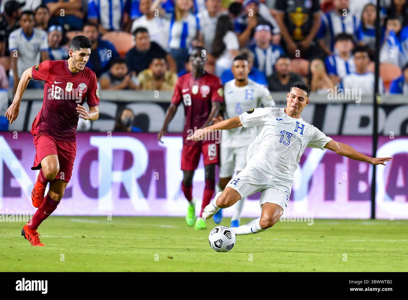 HOUSTON, TX - JULY 13: Honduras midfielder Edwin Solano (19) and Grenada  forward Benjamin Ettienne (2) fight to volley the ball during the CONCACAF  Gold Cup Group D soccer match between Honduras
