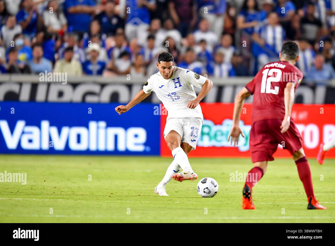 HOUSTON, TX - JULY 13: Honduras midfielder Edwin Solano (19) and Grenada  forward Benjamin Ettienne (2) fight to volley the ball during the CONCACAF  Gold Cup Group D soccer match between Honduras