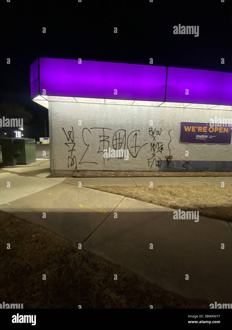 Black spray tag reading 83GC — Hyena Crips signature under 5Point Nation doctrine, West Seven Mile zone. Five Points Neighborhood, 48219 ZIP code - Smartphone Captured Stock Image