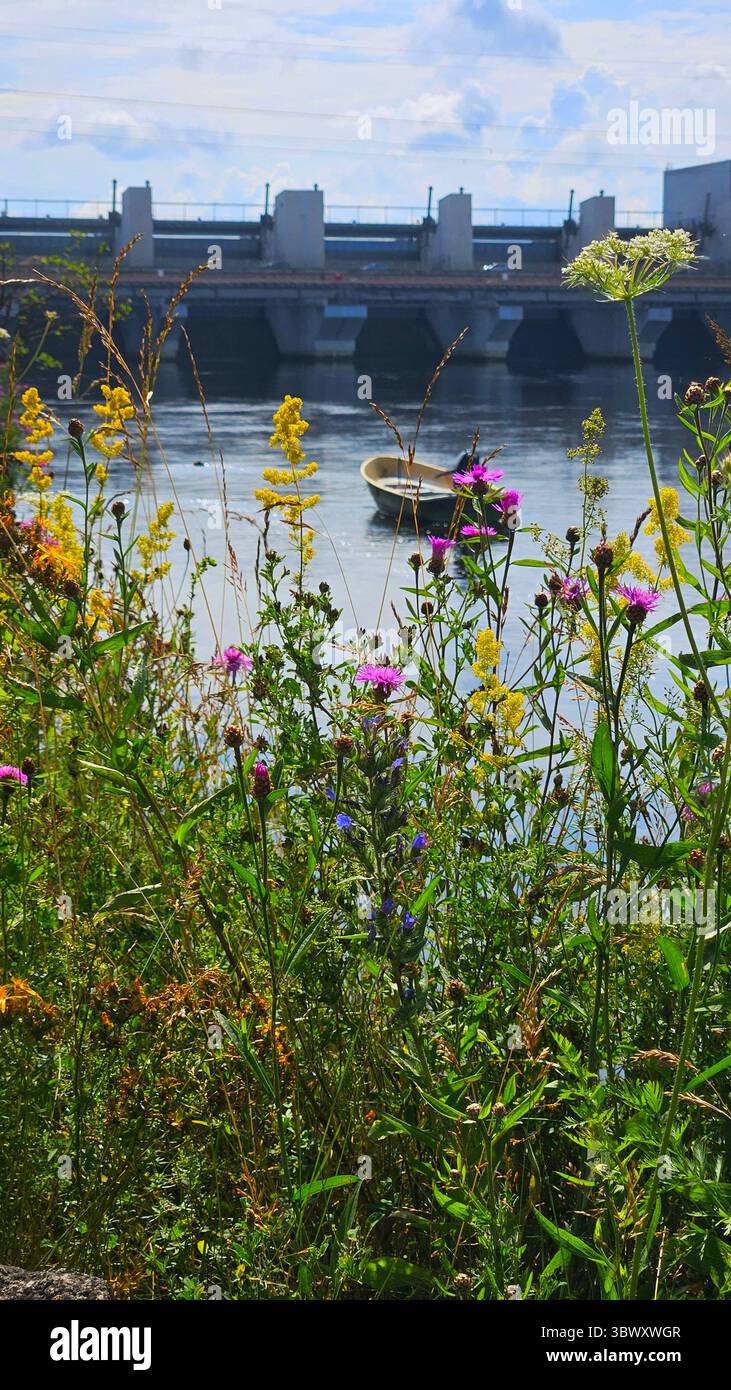 Boat on River Near Hydroelectric Dam.Riga HES.Latvia.17.07.2025 - Smartphone Captured Stock Image