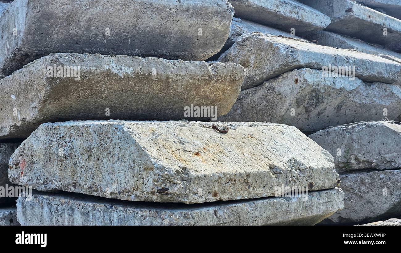 Abandoned Concrete Blocks in Overgrown Industrial Site - Smartphone Captured Stock Image