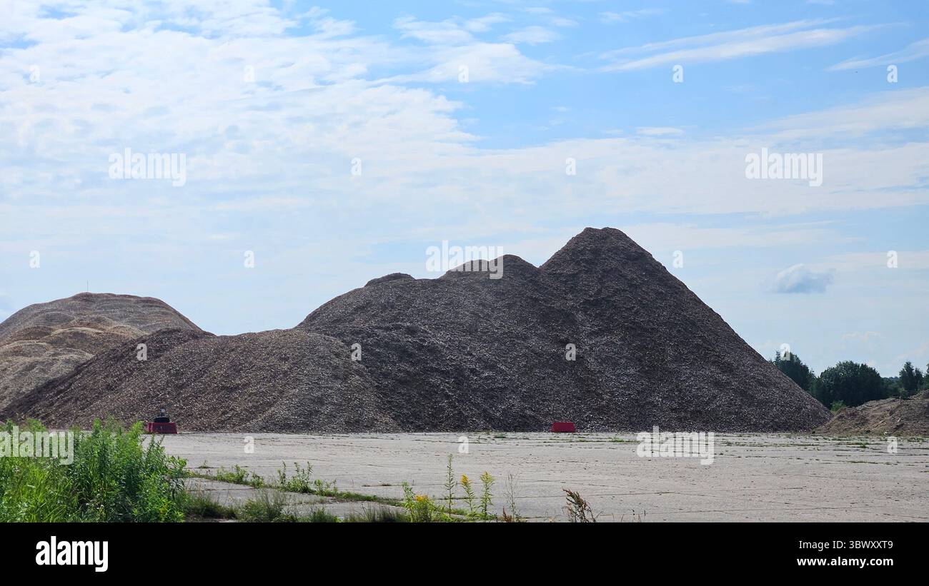 Massive Pile of Wood Chips with Red Barrier and Blue Sky - Smartphone Captured Stock Image