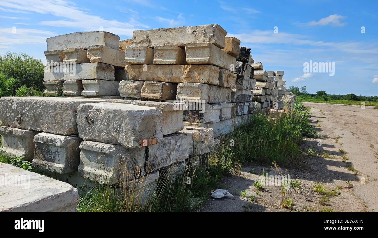 Abandoned Concrete Blocks in Overgrown Industrial Site - Smartphone Captured Stock Image