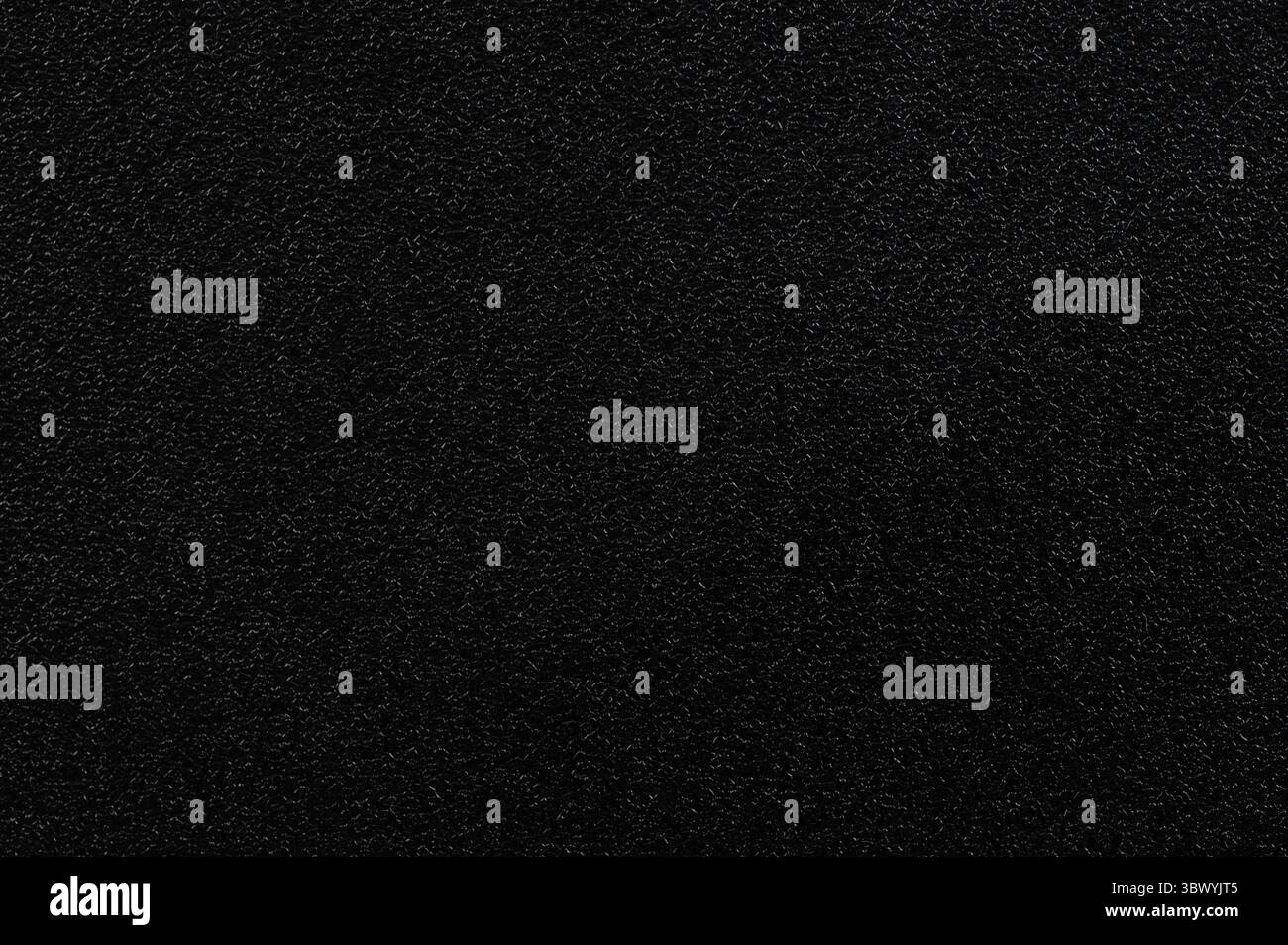 Black grainy plastic texture background pattern close up view Stock Photo