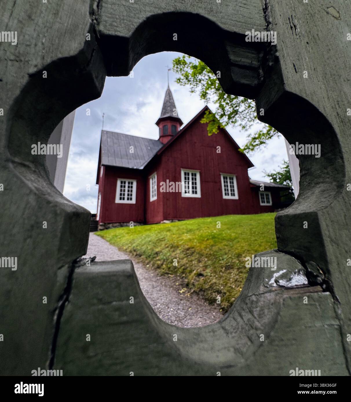 Wooden church of Fagervik, Inkoo, viewed through heritage fence design  Scandinavian architecture and cultural history. - Smartphone Captured Stock Image