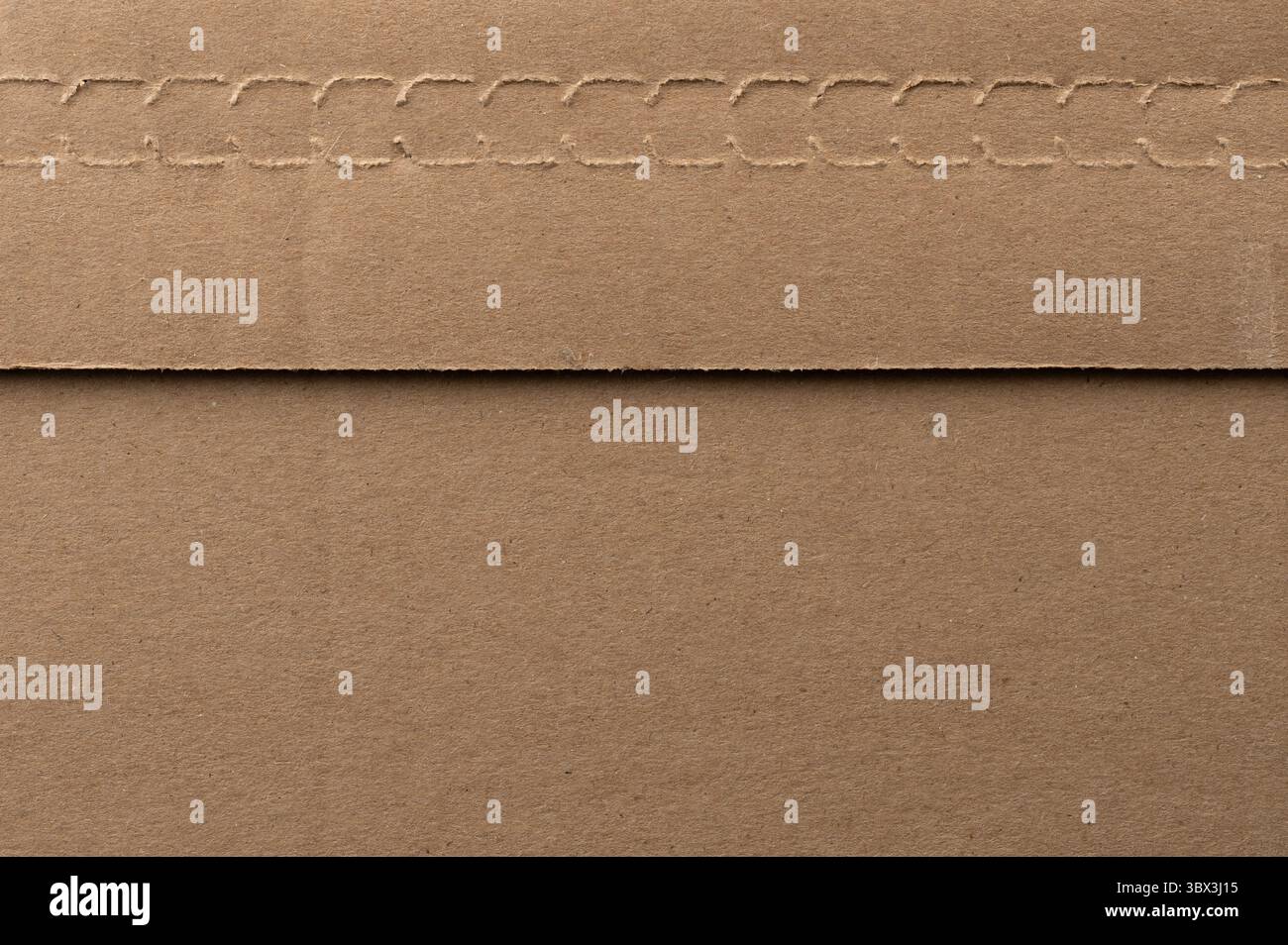 Brown paper envelope with stitched edge rests flat on smooth surface, showcasing its texture and simplicity. Stock Photo