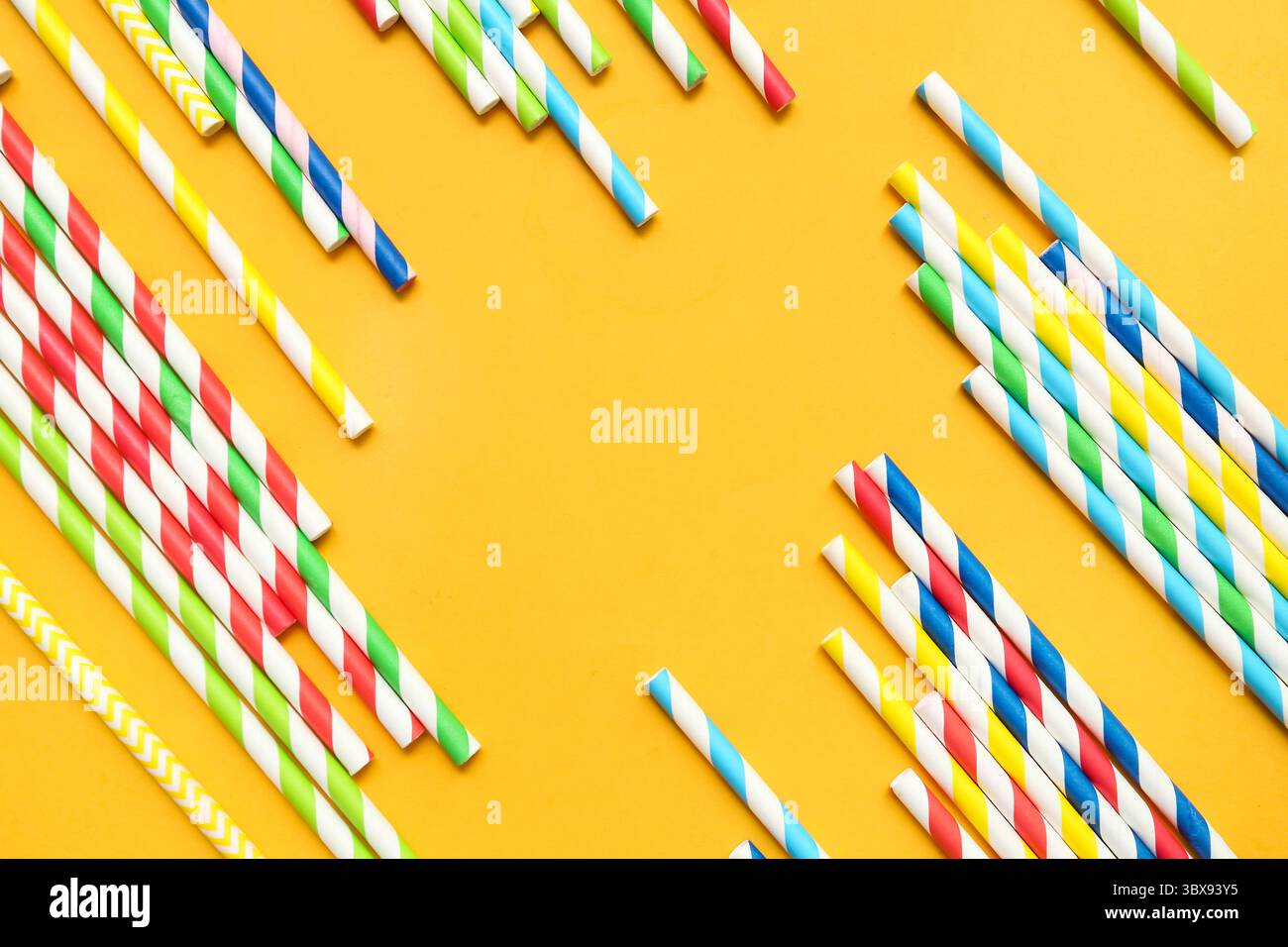 Different paper drinking straws on orange background Stock Photo