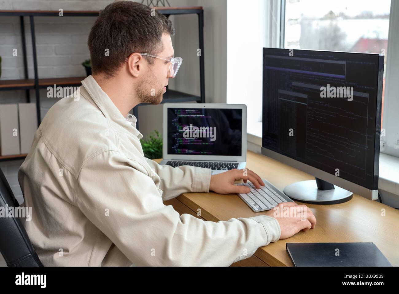 Focused male programmer working in office Stock Photo