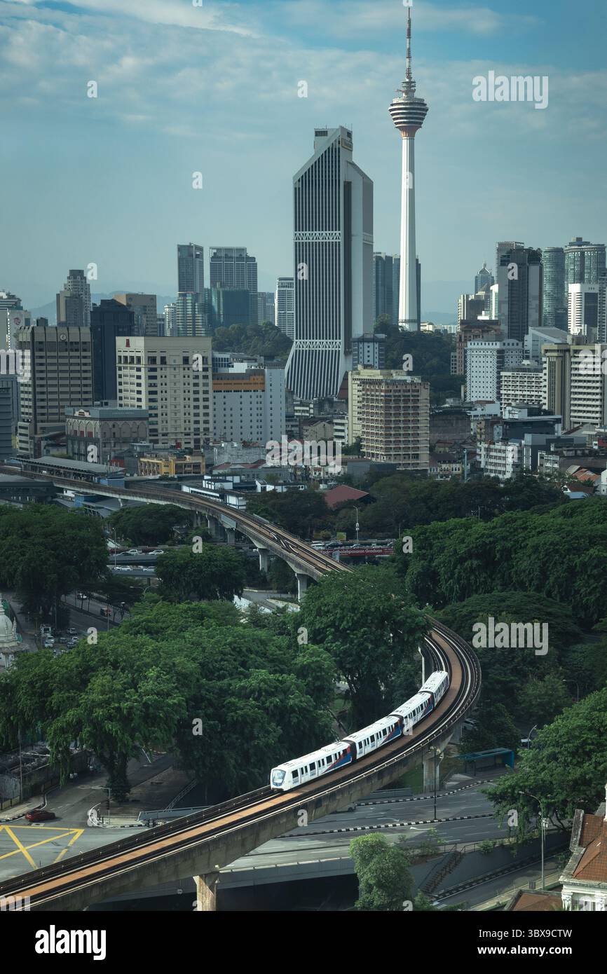 Lrt Risr Central Kuala Lumpur cityscape with a Light Rail Transit (LRT) train ...
