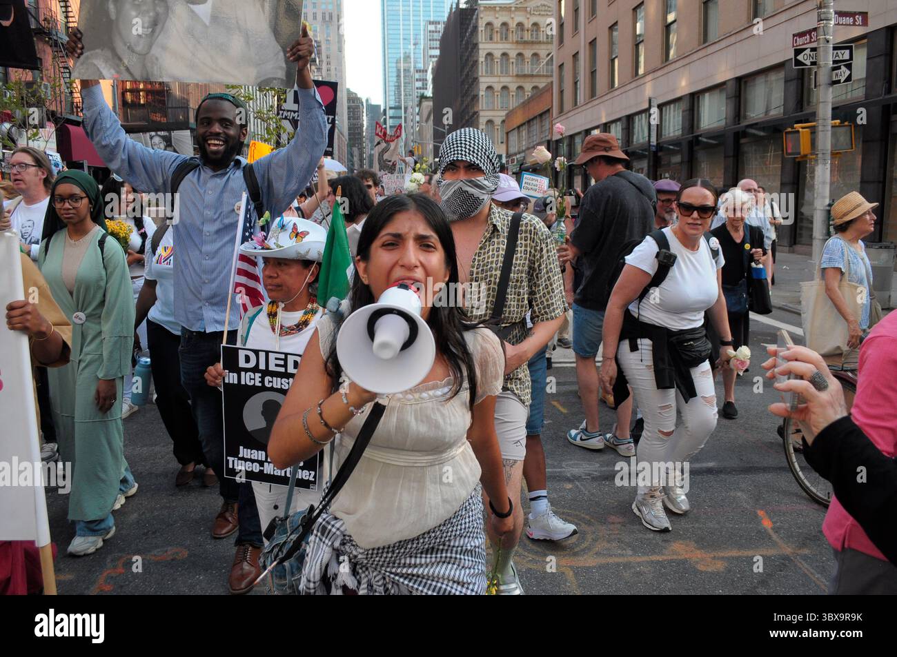 An anti-Trump demonstrator chants slogans using a megaphone while ...