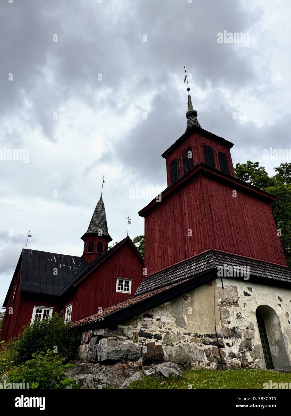 View of Fagervik Church tower from below under dramatic sky  historic wooden church in Uusimaa, Finland. - Smartphone Captured Stock Image