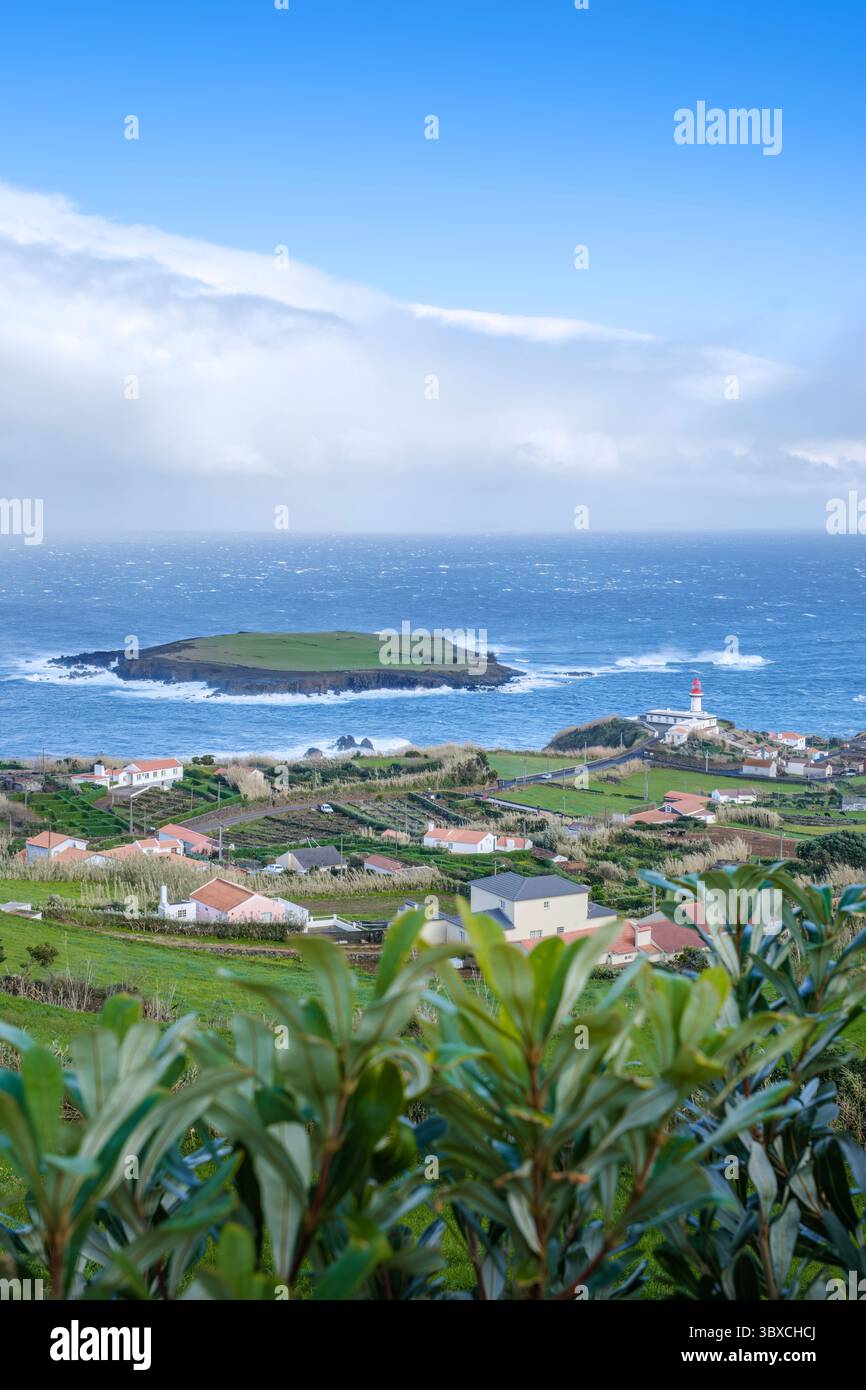 Ponta Do Topo Lighthouse With Dramatic Coastal Views To Ilheu da Ponta do Topo On Sao Jorge Island Azores Portugal. Atlantic Ocean volcanic landscapes Stock Photo
