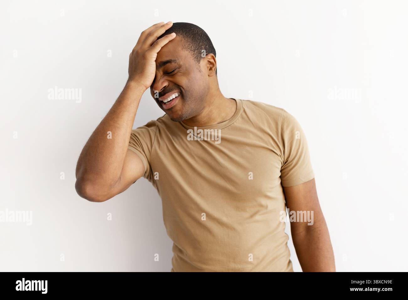 Black man with hand on forehead, reacting to problem Stock Photo