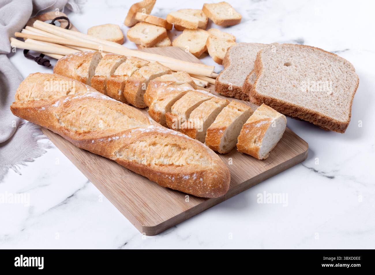 Assortment of Bread Products on white marble background Stock Photo