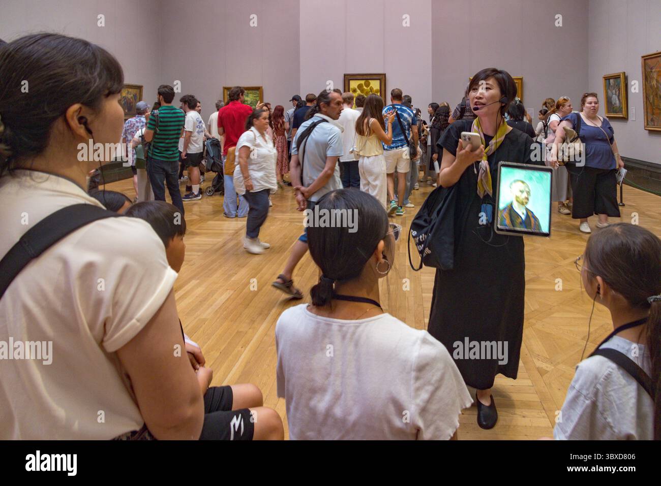 Japanese tour guide with group, National Gallery, London, UK Stock Photo