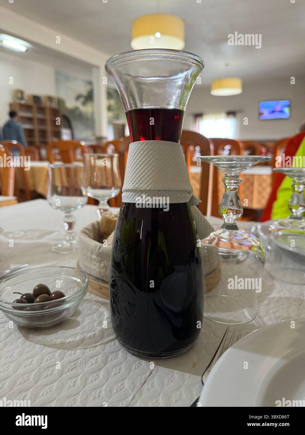 Carafe of red wine on a table in Portuguese restaurant - Smartphone Captured Stock Image