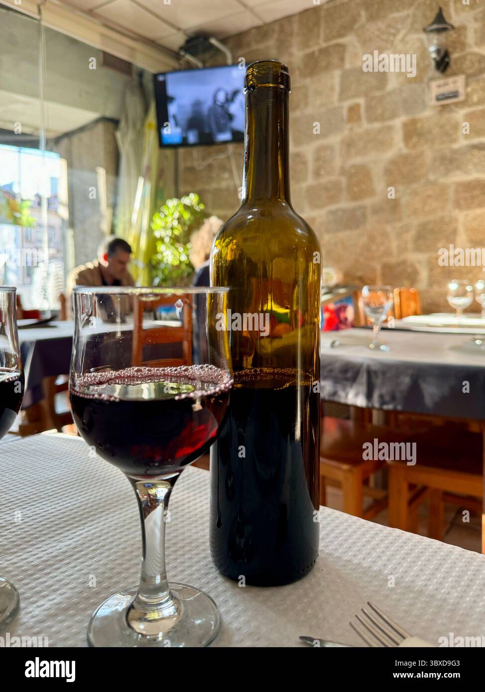 Glass of red wine and cleanskin bottle of wine. - Smartphone Captured Stock Image