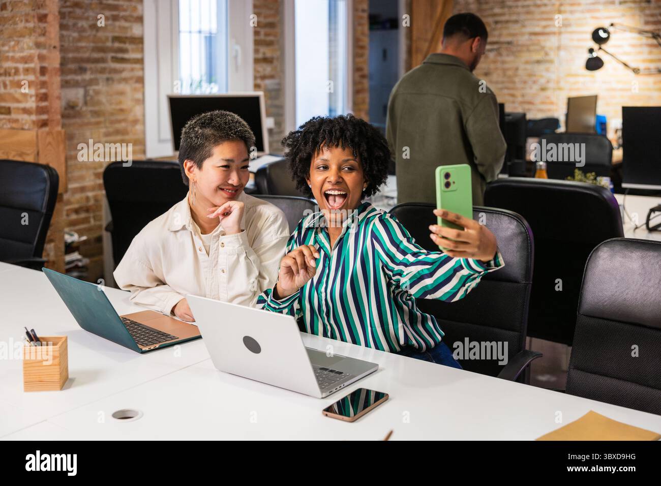 Multi ethnic team taking selfie in modern office Stock Photo