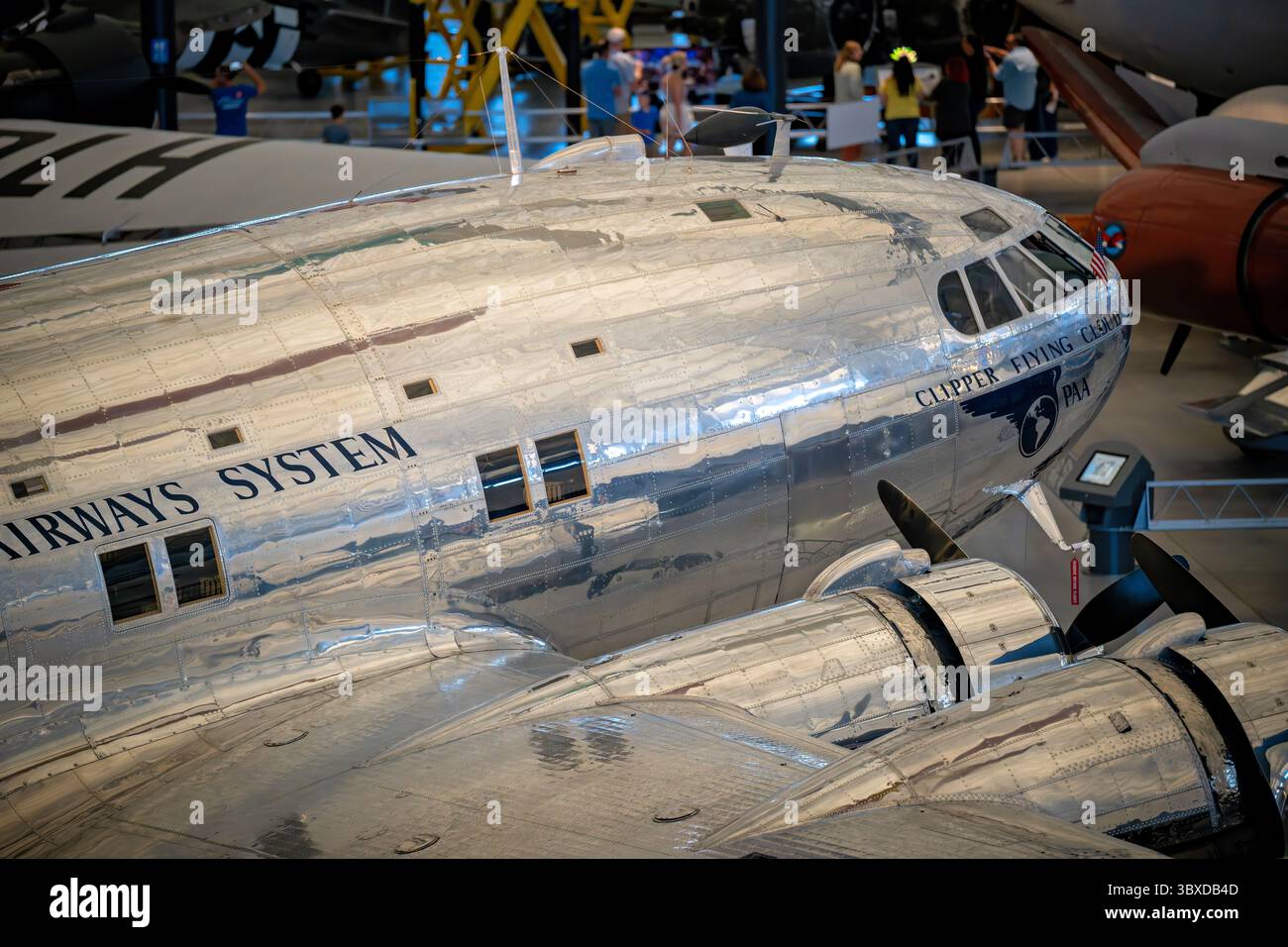 CHANTILLY, Virginia — The Boeing 307 Stratoliner Clipper Flying Cloud, the world's first pressurized airliner, is displayed at the Smithsonian's Steven F. Udvar-Hazy Center. First flown in 1938, the Stratoliner could carry 33 passengers at 6,096 meters (20,000 feet) while maintaining cabin pressure equivalent to 2,438 meters (8,000 feet), allowing flights above most weather systems. The aircraft incorporated wings, tail, and engines from the Boeing B-17C bomber with a wide fuselage fitted with sleeper berths and reclining seats. Pan American Airways operated this particular aircraft as part of Stock Photo