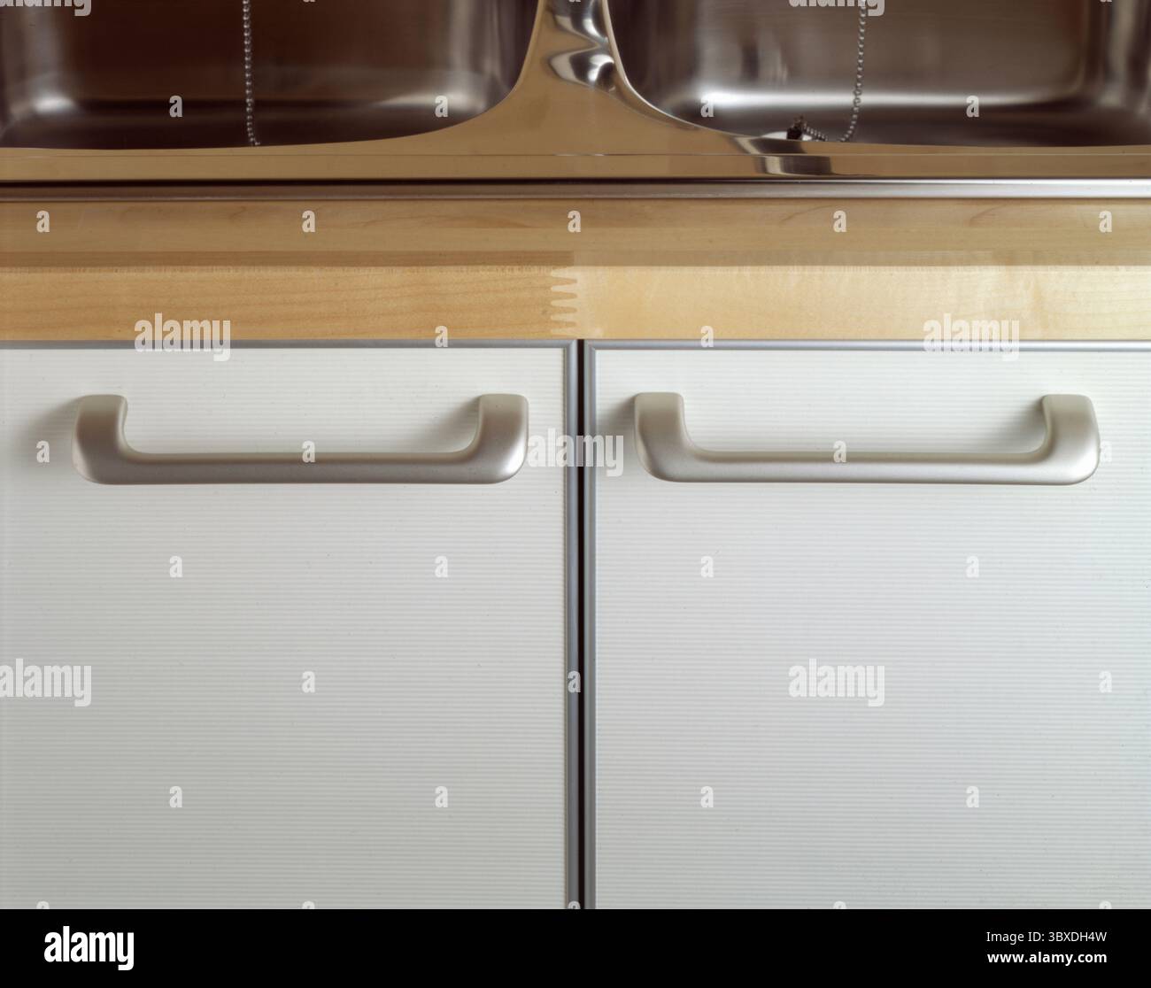 Close up on the handles of a kitchen cabinet with sink Stock Photo - Alamy