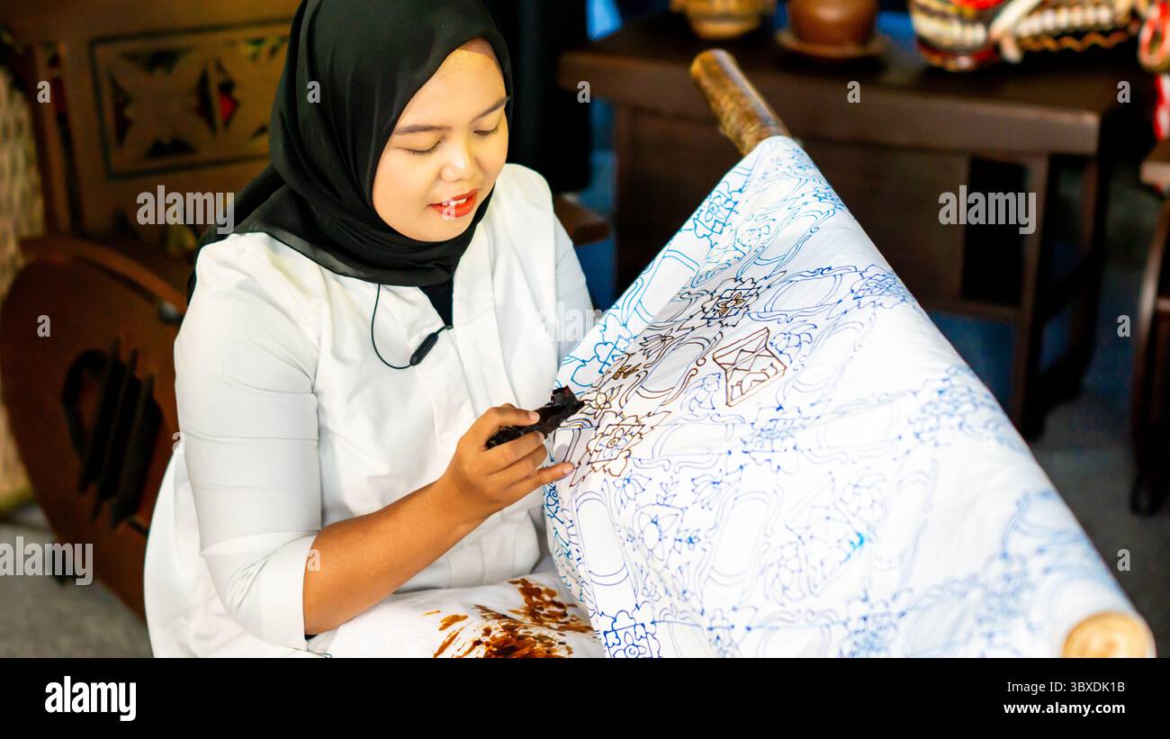 The process of making batik cloth. Batik is a type of cloth whose ...