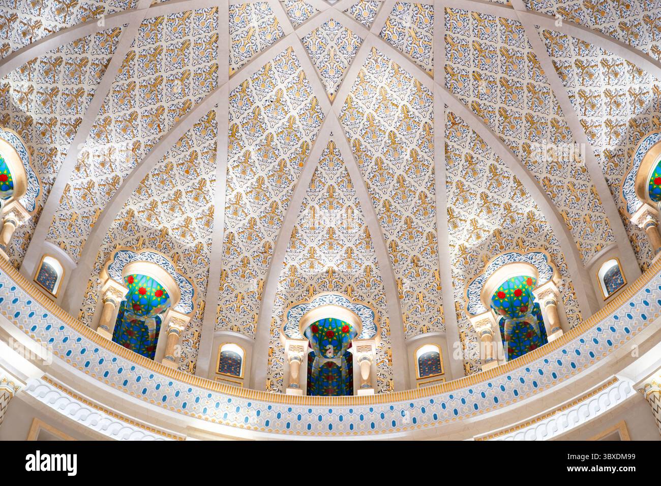 Detailed architectural dome with intricate patterns and colorful stained glass windows, showcasing opulent and ornate design Stock Photo