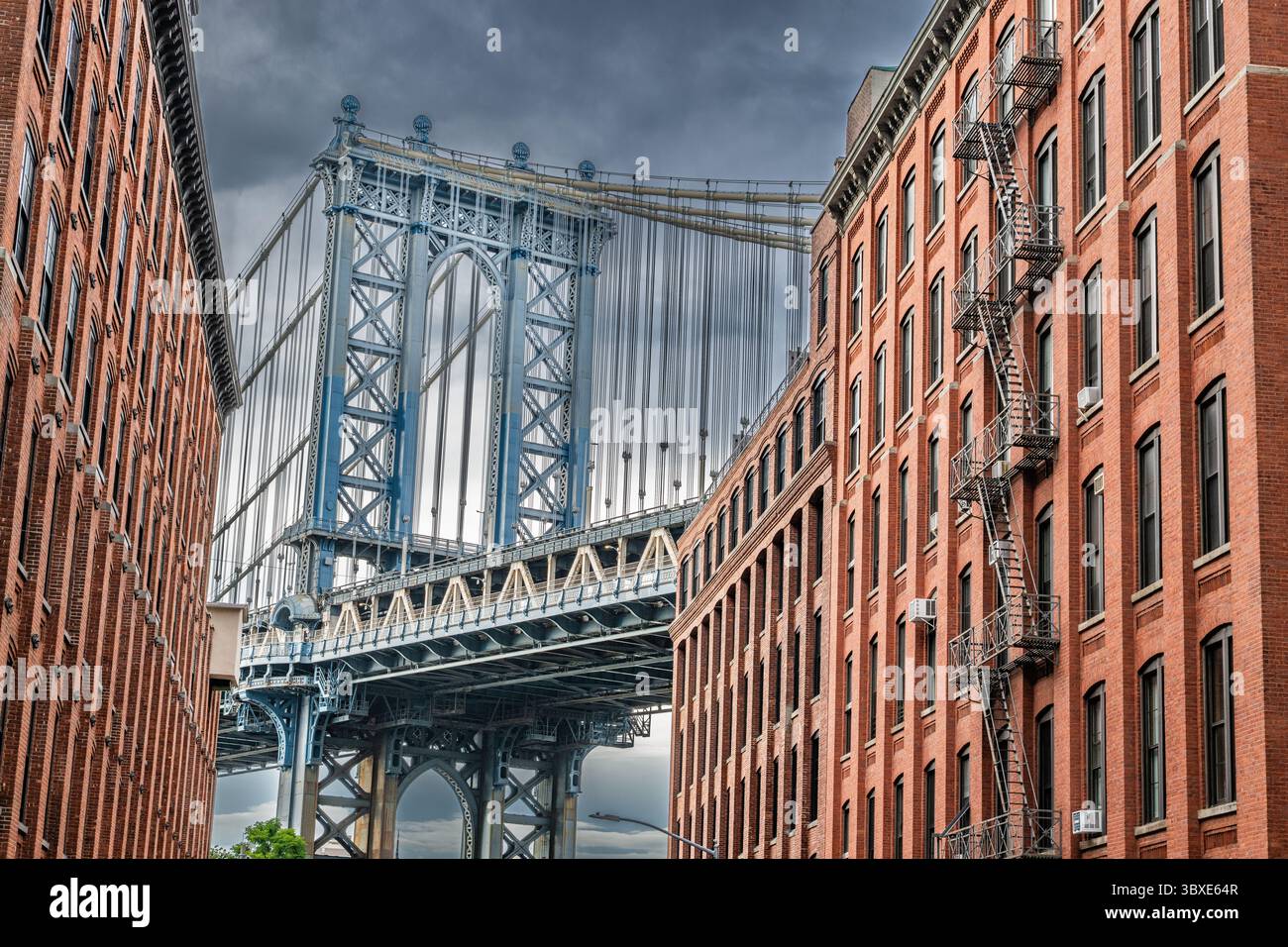 Manhattan Bridge in Brooklyn New York City - closeup detail of suspension bridge cables tower and architecture - Dumbo buildings Stock Photo