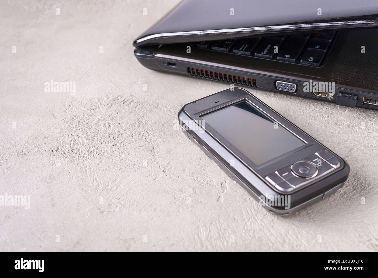 Laptop, smartphone lie on the table, place for text Stock Photo