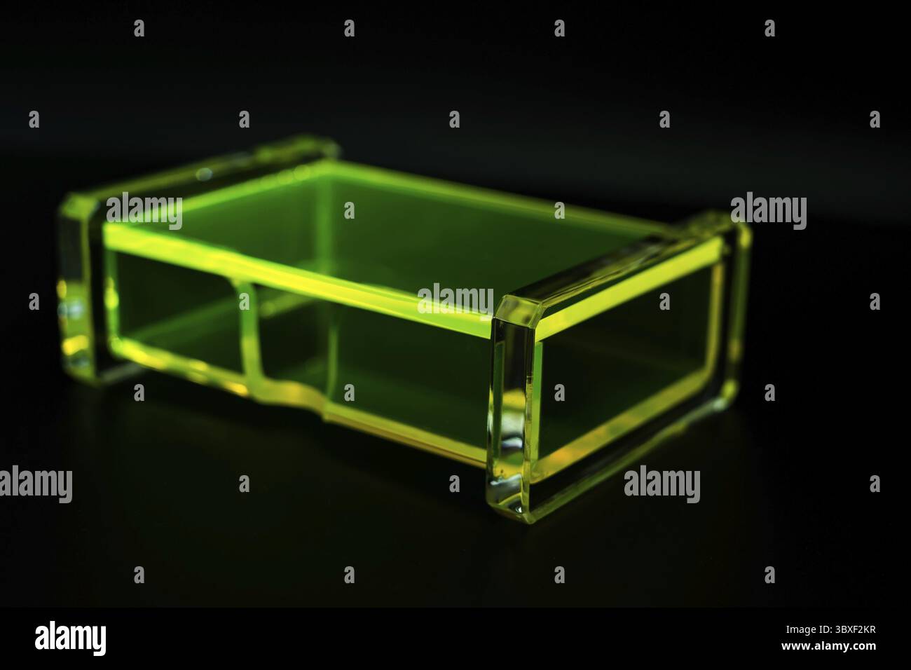 Abstract green transparent plastic box dark background Stock Photo