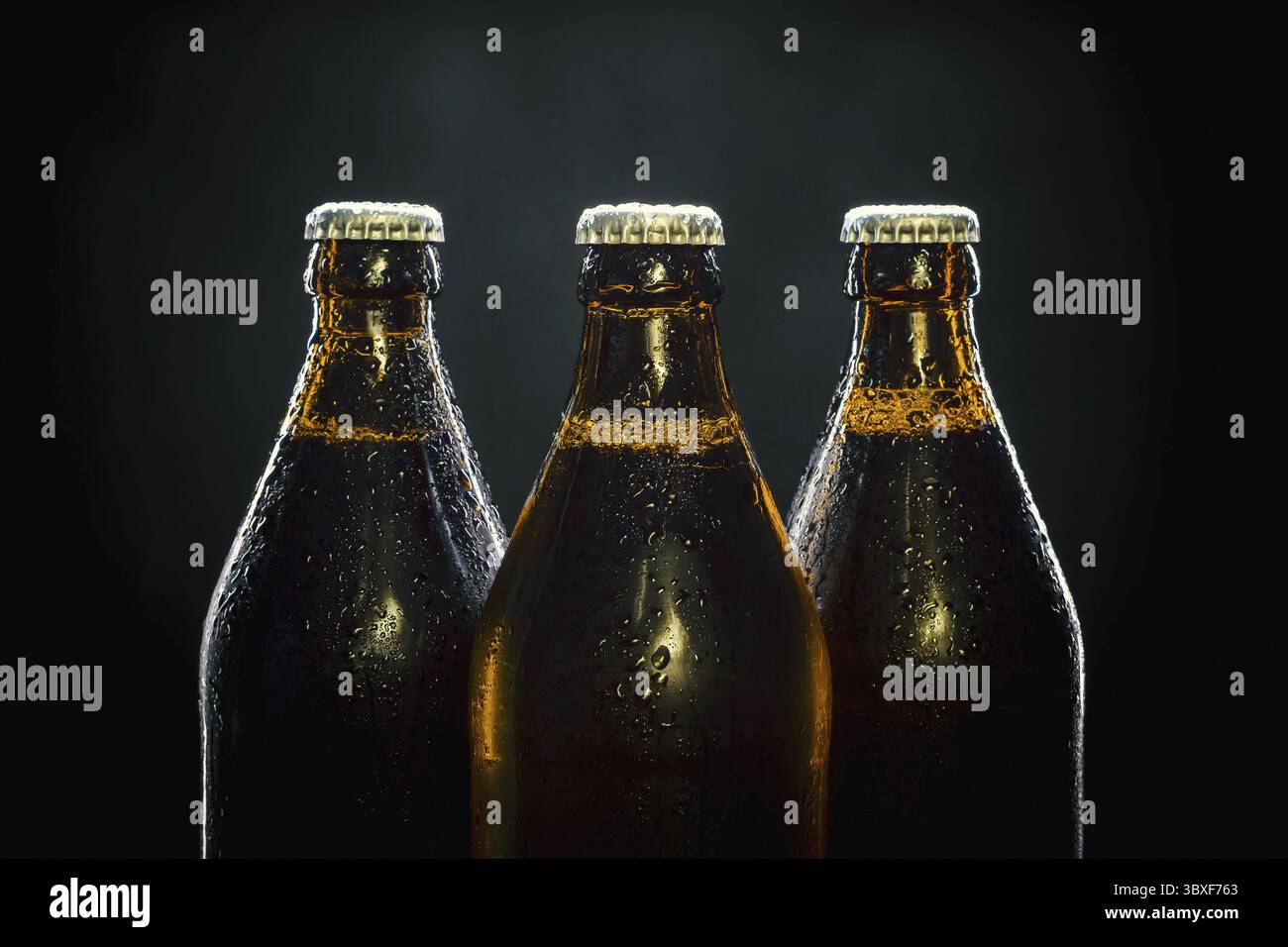 Three cool beer bottles on black background Stock Photo