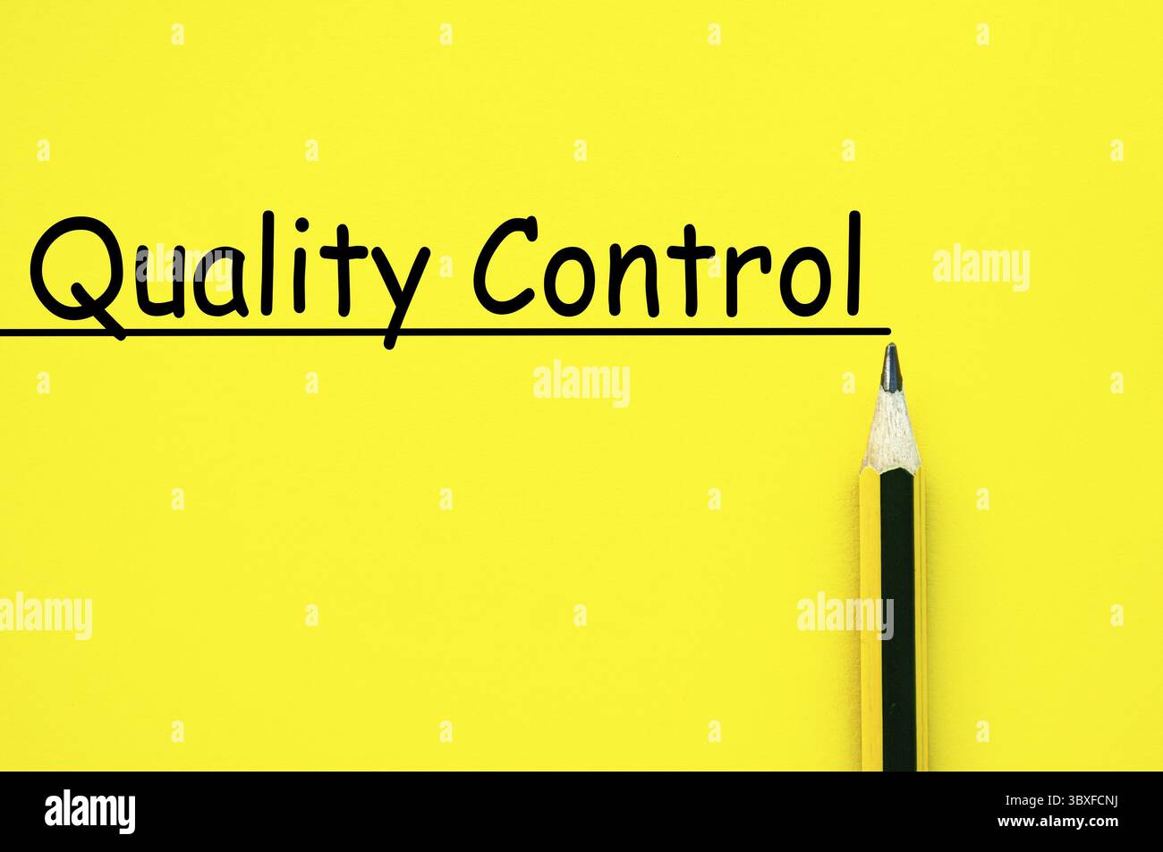 Quality control text written on yellow paper background Stock Photo