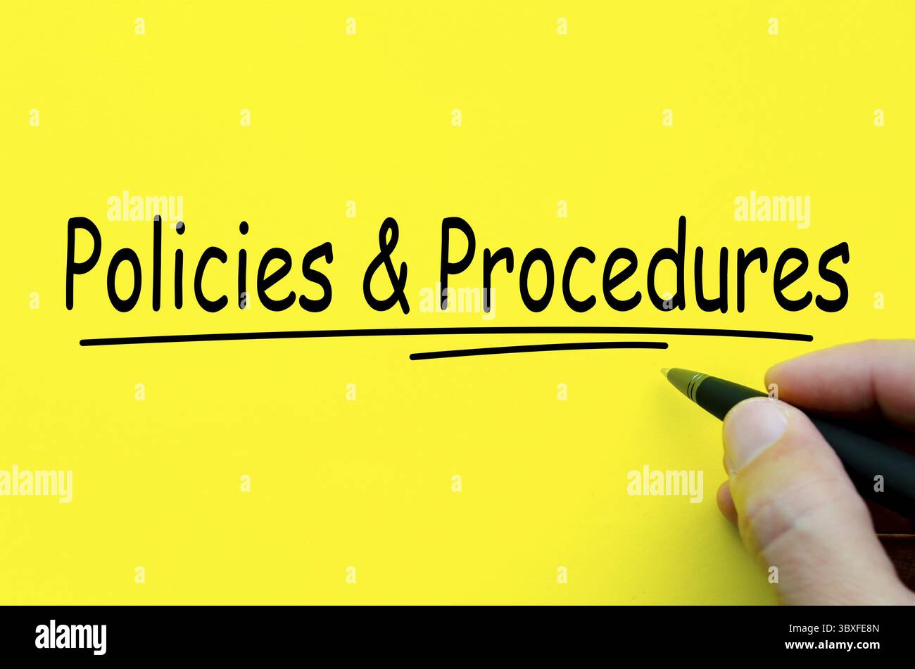 Policies and Procedures hand written text on yellow notepad Stock Photo