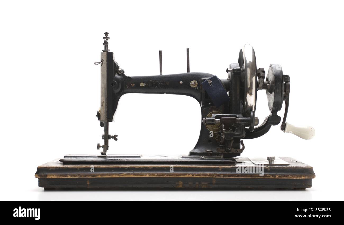 Old sewing machine isolated on a white background Stock Photo - Alamy