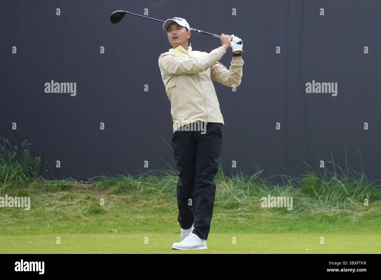 Sadom Kaewkanjana of Thailand plays his tee shot on the first hole