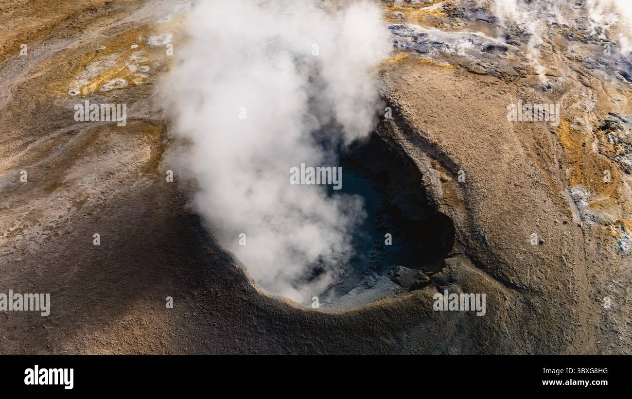 Explore the stunning geothermal landscape of Hverir in Iceland, featuring vibrant soil colors and billowing steam vents. A natural spectacle of earths power awaits the adventurous traveler. Stock Photo